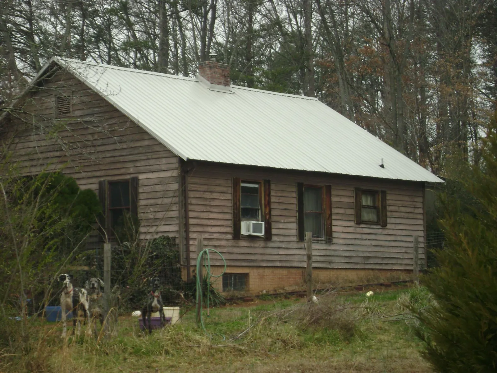 White metal roof on an old wood sided farmhouse, from a Metal Roof Installation job in Turbotville
